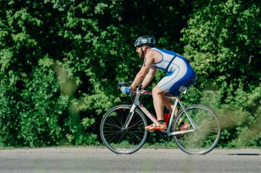 Kharkiv, Ukrayna - 11 Ağustos 2019: Bisiklet yarışması. Triatloncu, güneşli bir günde triatlon yarışmasında yüksek hızda at sürüyor.