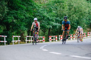 KHARKIV, UKRAINE - 2 Ağustos 2020 Demir Adam yarışması sırasında triatoncu bisikletli triatloncu bisikleti. Üç takım elbiseli ve kasklı bir bisiklet sporcusu. Halka açık etkinliklere izin var. CV salgını sırasında Avrupa sporu.