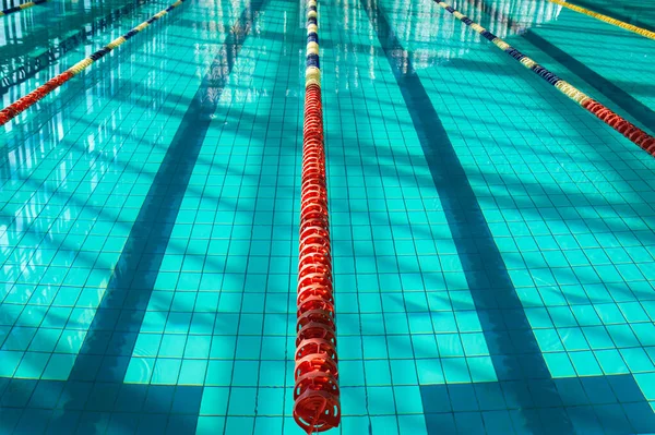 The sports swimming pool. Divided swimming lanes for swimmers,