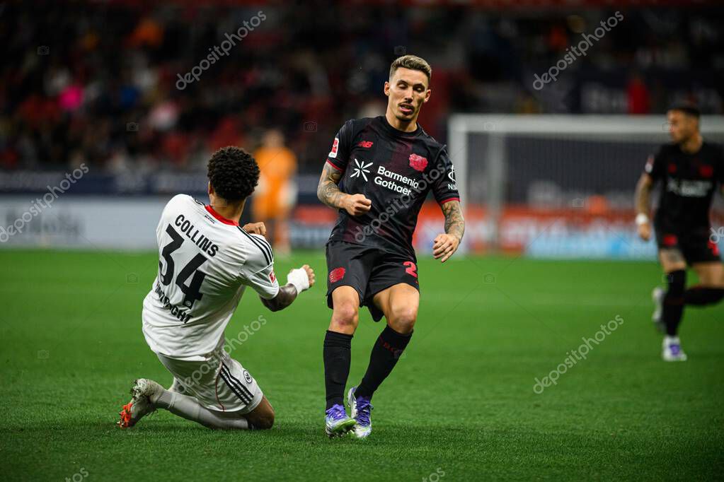LEVERKUSEN, GERMANY - 12 SEPTEMBER, 2025: Nnamdi Collins, Alejandro Grimaldo - The Bundesliga match Bayer 04 Leverkusen vs SG Eintracht Frankfurt at BayArena.