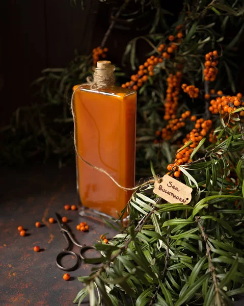 Sea buckthorn syrup in an old bottle