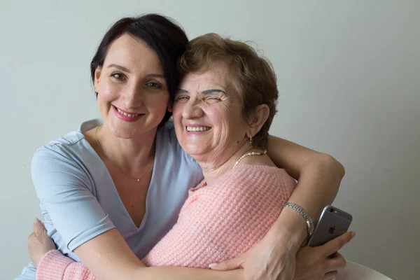 Elderly mother hugging adult daughter concept affection Royalty Free Stock Images