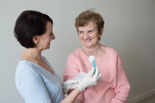 Positive  nurse medical exam retired woman Stock Picture