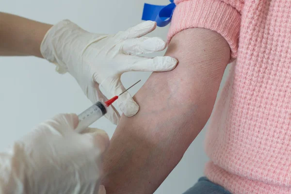 Caregiver hands sterile gloves flu shot closeup Royalty Free Stock Images