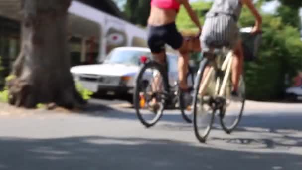 Két névtelen GILS lovaglás kerékpárok napsütéses nap — Stock videók