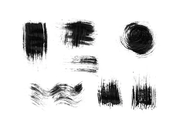 Black paint strokes set on a white background — Stock Photo, Image