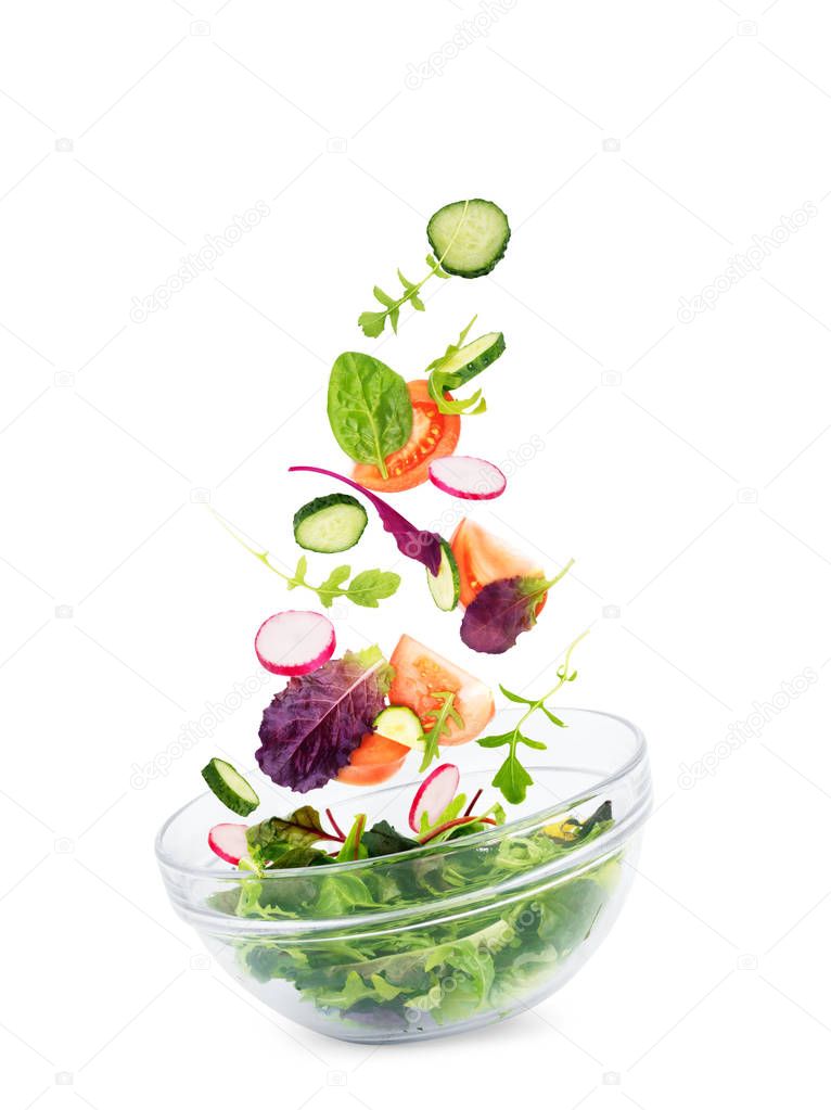 Falling vegetables for salad isolated on white