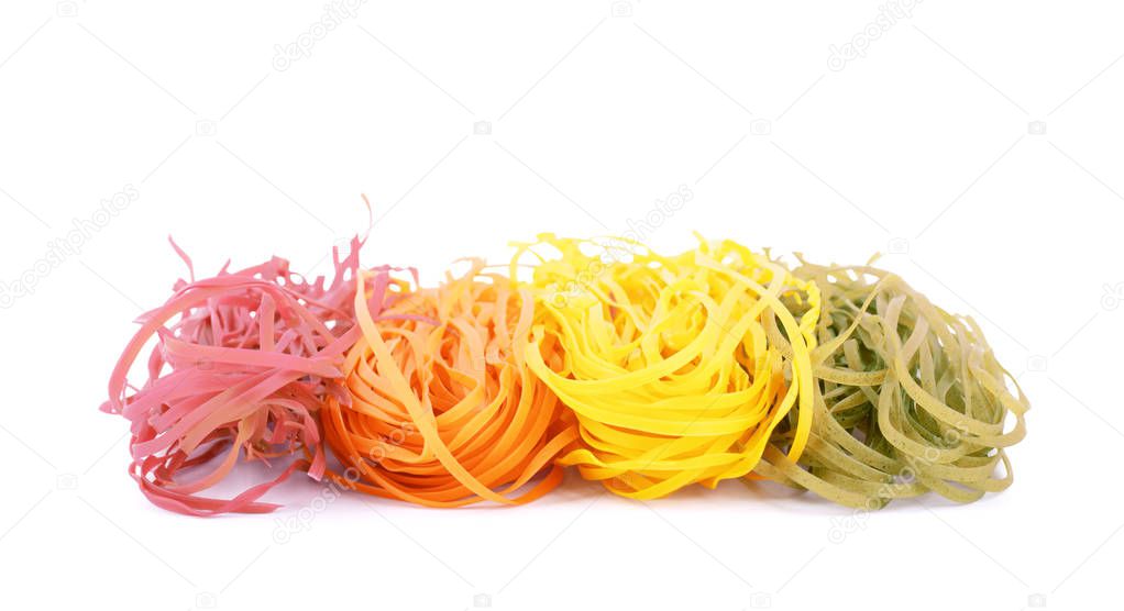 Multicolored pasta tagliatelle on white background