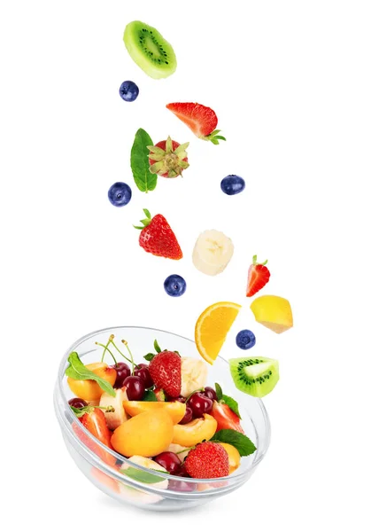 Fruit salad in a transparent plate on a white background — Stock Photo, Image