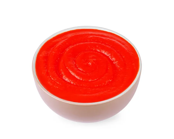 Pâte de tomate dans une assiette sur fond blanc — Photo