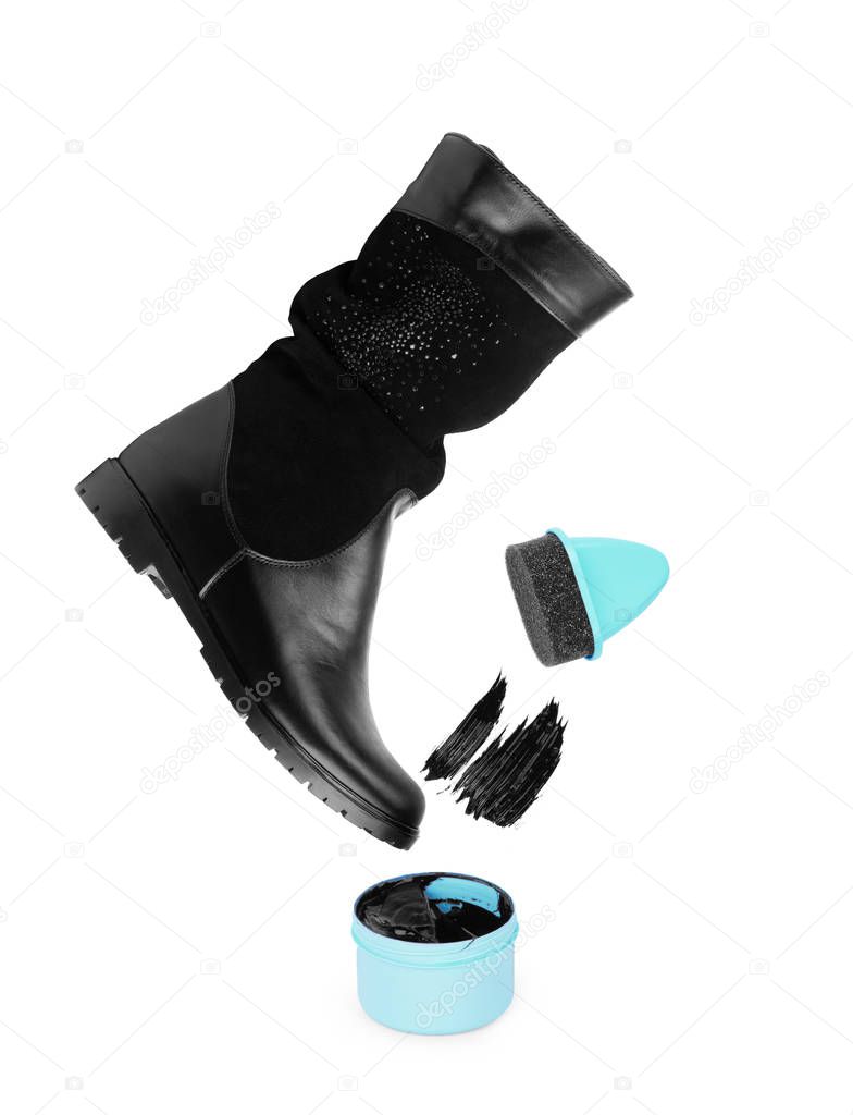 Black shoe polish lid ajar on a white background