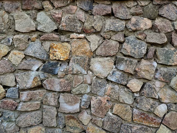 Background of large stones wall texture with different colors stones