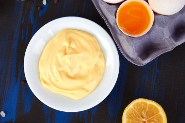 Ev yapımı Sos mayonez ve malzemeler yumurta, yağ, limon, koyu mavi zemin üzerine mustar. Top vie