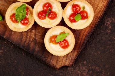 Mini tart kiraz domates ile ahşap tahta üzerinde mozzarella peyniri ile. Üstten Görünüm. Kopya alanı.