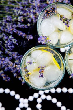 Lavanta Limonata limon ve siyah arka plan üzerine buz. Suyu detoks. Yaz içeceği. Diyet kokteyl. Güzel. Üstten görünüm. Kopya alanı.