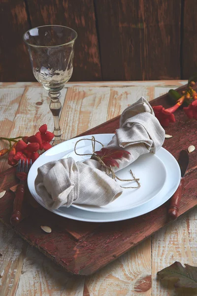 Fall table setting for Thanksgiving day celebration on wooden background. Autumn table setting.