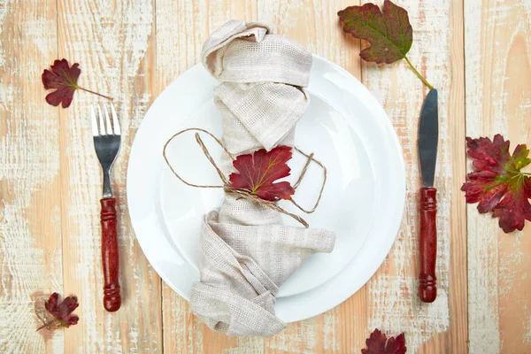 Fall table setting for Thanksgiving day celebration on wooden background. Autumn table setting. Top view. Falt lay. Copy space.