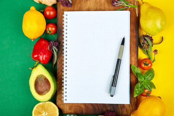 Shopping list, recipe book, diet plan. Fresh raw vegetables, fruit and ingredients for healthy cooking. top view, place for text. Diet or vegan food, healthily cooking concept. Flat lay. Notepad for your recipe concept.
