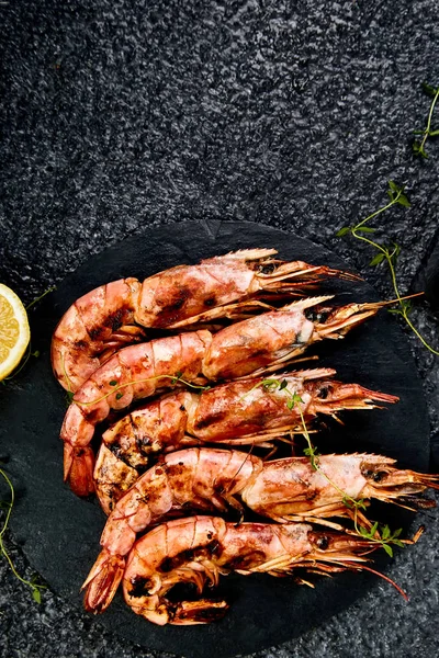 Izgara büyük kaplan karidesler siyah arduvaz plaka üzerinde karides