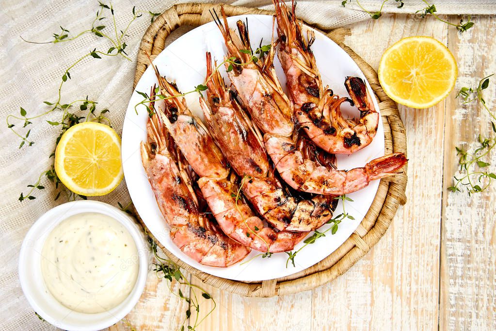 Grilled big tiger shrimps prawns on white plate