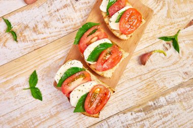 Domatesli bruschetta, mozzarella peyniri ve fesleğen. 