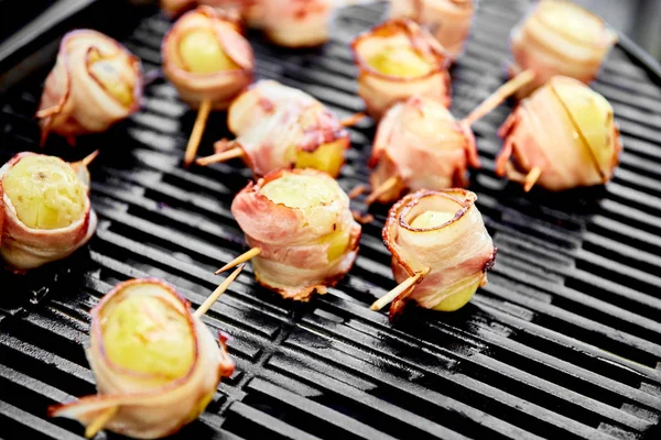 Grilled potato with bacon on gas grill . Grilled food. Barbecue. Copy space. Healthy food.