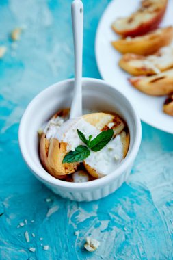 Beyaz tabakta dondurma ile ızgara şeftali