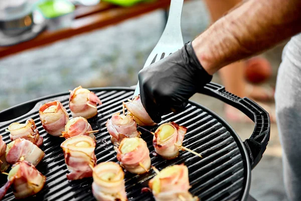 Grilled potato with bacon on gas grill . Grilled food. Barbecue. Copy space. Healthy food.