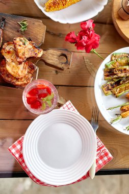 Et ızgaralı yemek masası, kızarmış sebzeler, soslar ve limonata. Parti masasında servis edilen aperatifler.