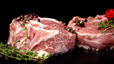 Ekolojik saf et, eko ürün kavramı. Domuz eti bonfile, çiğ et baharatlar ile siyah zemin mermer. yan görünüm, kopya alanı