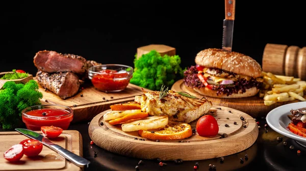 American fast food, burgers, french fries, meat and chicken steaks. Background image. set of several dishes. Copy space