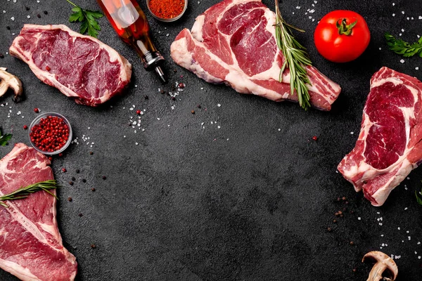 Meat Raw Steaks Lie Black Background Vegetables Tomatoes Marasmade Mushrooms — Stock Photo, Image