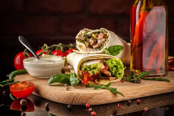 Meksika mutfağı, börek tavuk, domates, marul, mantar, rucola ve siyah bir zemin üzerine pul biber. Salsa sos ile. Kopya alanı, seçici odak