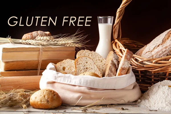 The concept of gluten-free bread at work and at home. Gluten free bread and rolls in a wicker basket stand on the table, next to a bottle of milk.Copy space, selective focus