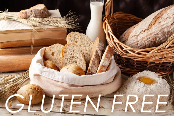 The concept of gluten-free bread at work and at home. Gluten free bread and rolls in a wicker basket stand on the table, next to a bottle of milk.Copy space, selective focus