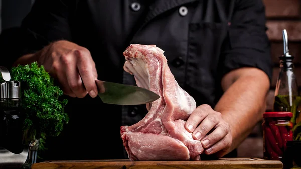 Et pişirme kavramı. Yalan çiğ sebze, kiraz, maydanoz, dereotu yanındaki ahşap bir masa üzerinde elinde bir bıçak tutan adam aşçı, kasap, sığır eti, kuzu, Dana, çiğ et keser.