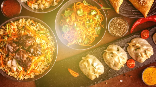 Assorted Uzbek food set, pilaf, samsa, lagman, manta and Korean carrots, Uzbek restaurant concept, Uzbek food feast. Festive, homemade lunch, dinner for the whole family. copy space, top view — Stock Image Assorted Uzbek Food Set Pilaf Samsa Lagman Manta Korean Carrots Royalty Free Stock Photos