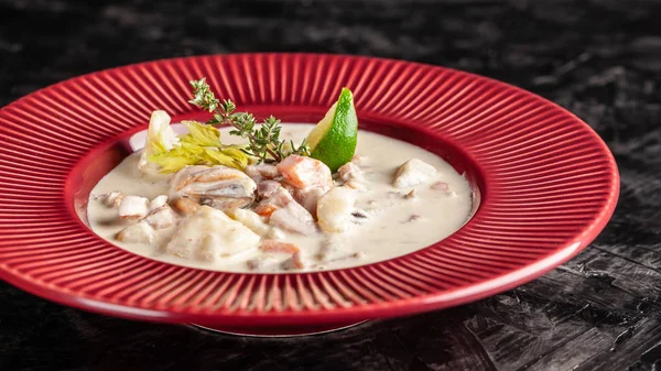 The concept of American cuisine. Clam chowder potato soup with sea food, mussels, salmon. Fish broth soup with milk. Serving dishes in the restaurant. copy space