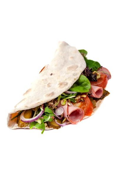 The concept of Italian cuisine. Piadina with ham, tomatoes, lettuce mix, pistachios and cucumbers on a white background. Isolate — Stock Photo, Image