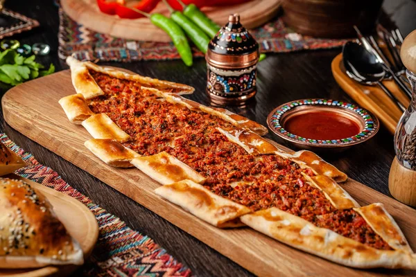 Традиционная турецкая кухня. Турецкая пицца Пита с мясом. Тёрк Пидези или Сукук Пидэ. Озил подает блюда в ресторане. Фоновое изображение. копировальное пространство Лицензионные Стоковые Изображения