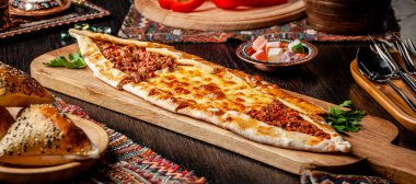 Geleneksel Türk mutfağı. Farklı bir dolma, et, peynir, dana eti dilimleri ile Türk pizza Pide. Turk Pidesi veya Sucuk Pide. Restoranda yemek servisi. Kopyalama alanı