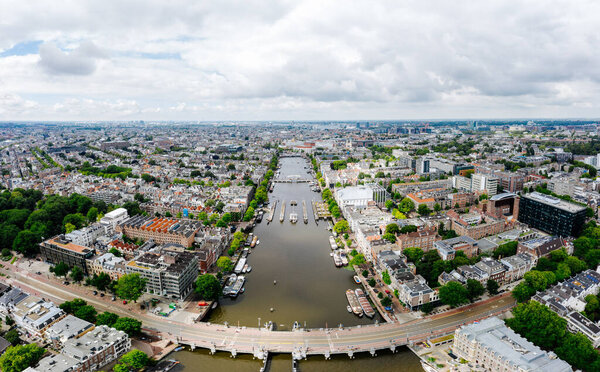 Beautiful aerial Amsterdam view from above with many narrow canals, streets and architectures