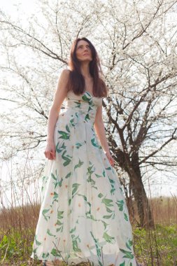 mavi gözlü parlak güneşin tam büyüme çiçek bahçesinde ince kahverengi saçlı kadın