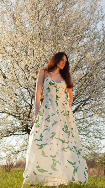 mavi gözlü parlak güneşin tam büyüme çiçek bahçesinde ince kahverengi saçlı kadın