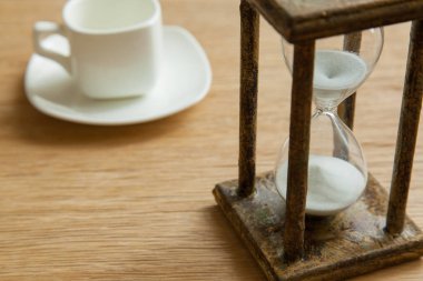 Kum saati zaman geçen kavram olarak meşe masada iş son tarih, aciliyet ve zamanın dışında çalışan.