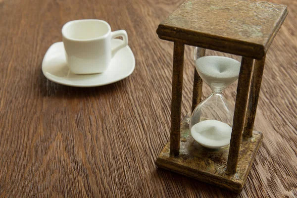 Kum saati zaman geçen kavram olarak meşe masada iş son tarih, aciliyet ve zamanın dışında çalışan.