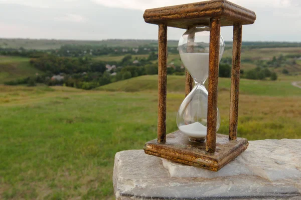 hourglass as a symbol of the passing time stand on a white stone marble