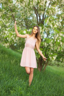 cinsel kız uzun saç güneşli öğleden sonra çiçek açması beyaz akasya karşısında çözünmüş