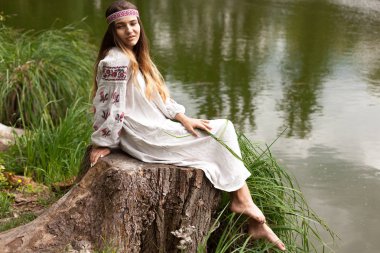 Güzel ince Ukrayna dili nakış gölün kıyısında güneşli bir yaz doğası sahiptir