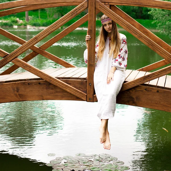 Güzel ince Ukrayna dili nakış köprüde su üzerine oturur.